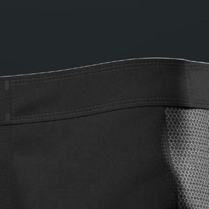 Close-up of a black garment with mesh lining on a dark background