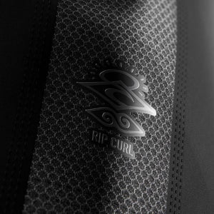 Close-up of a Rip Curl logo on a textured surface