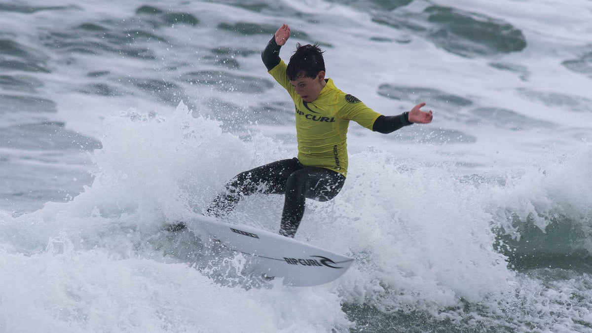 Grom surfing in their heat