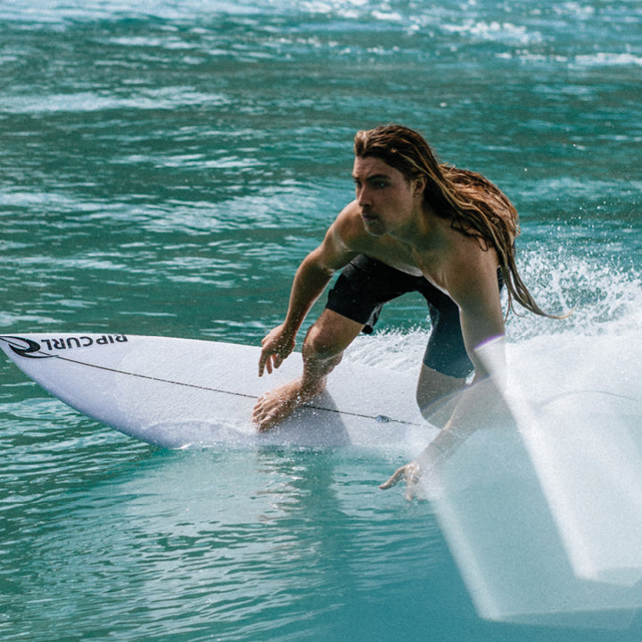 Oscar surfing in Rip Curl boardshorts in Byron Bay