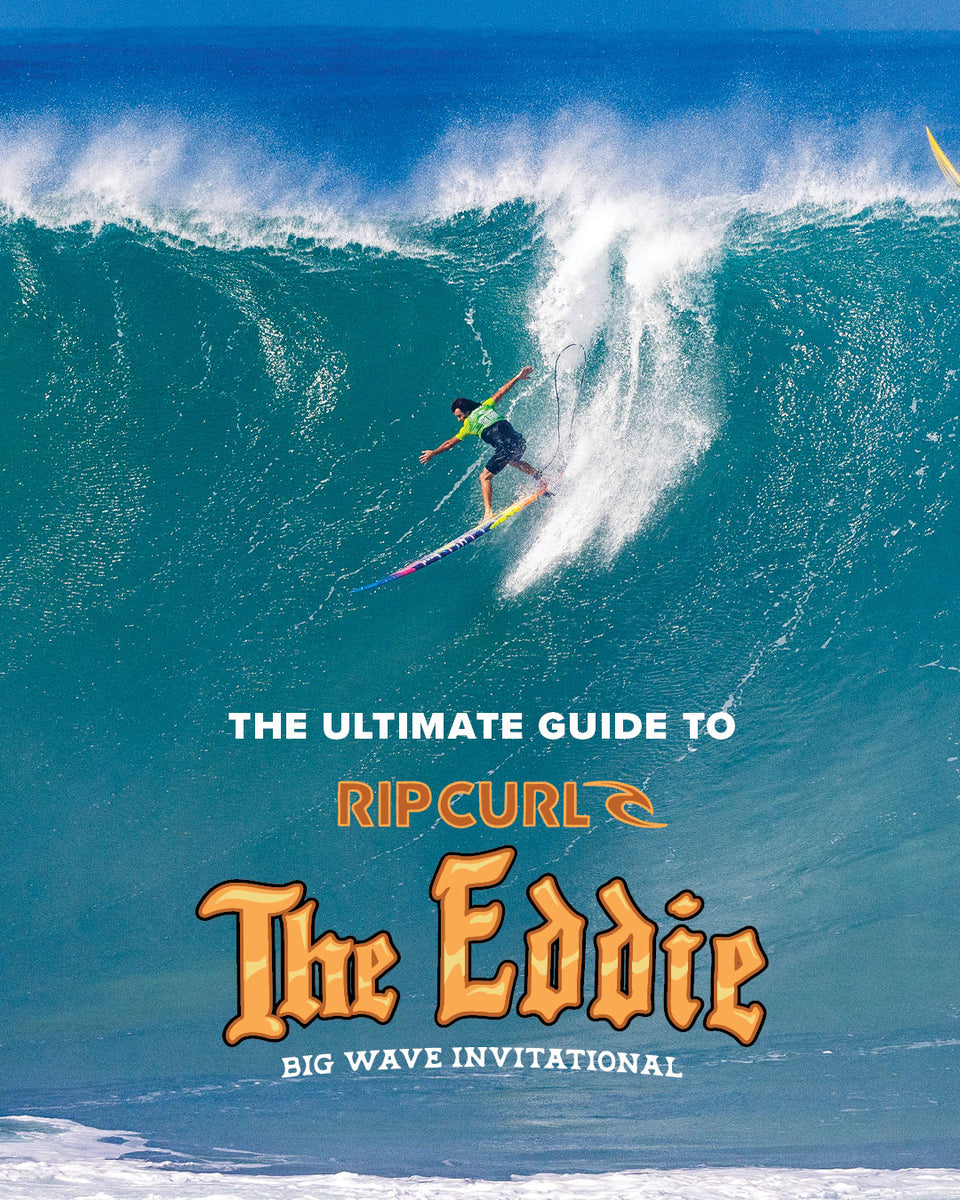 Surfer riding a wave with Rip Curl The Eddie logo on a blue background