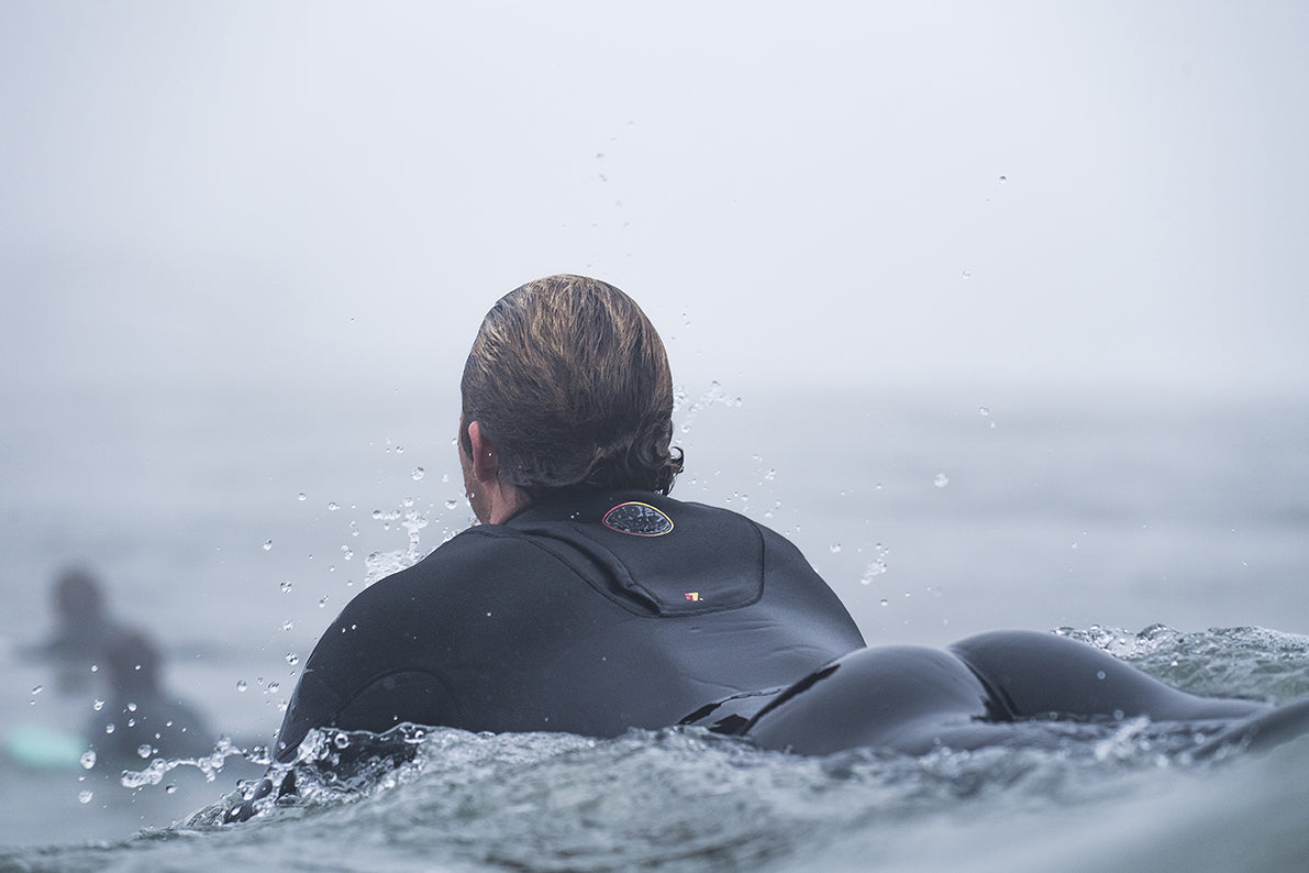 Close view of a surfer into the waves