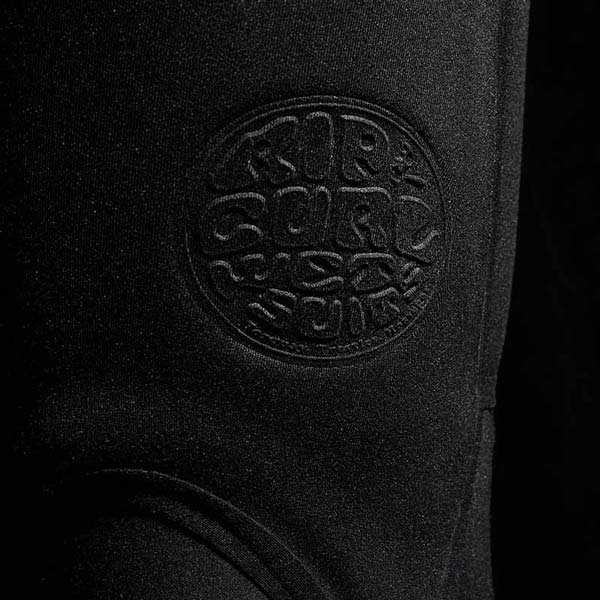Close-up of a black wetsuit with a brand logo on a dark background