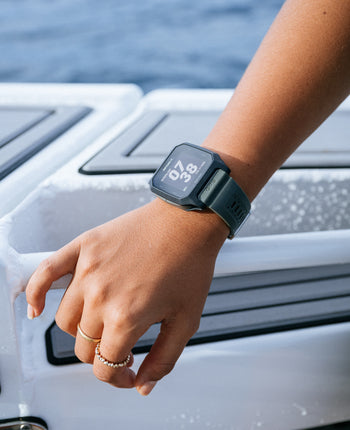 Person wearing a smartwatch on a boat