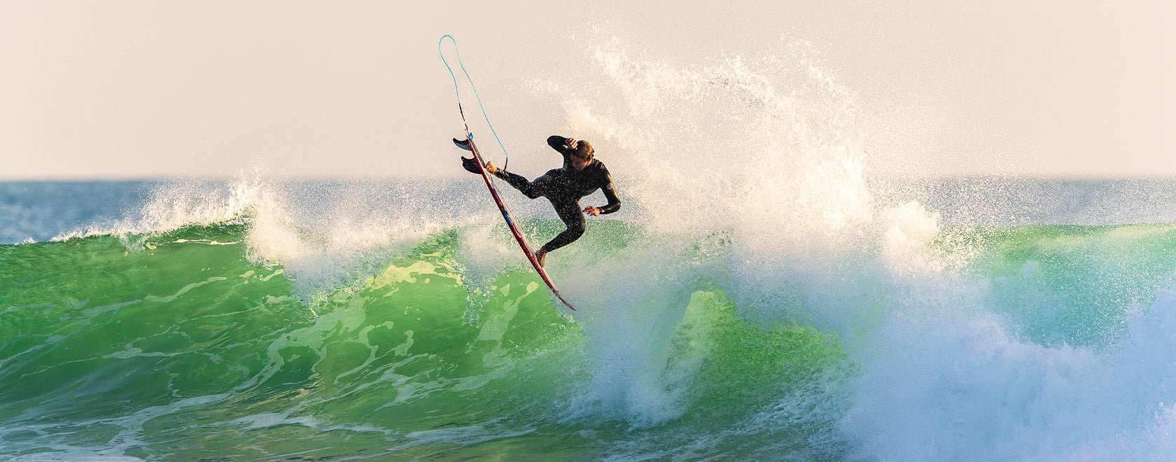 Person surfing on a wave with a clear sky background