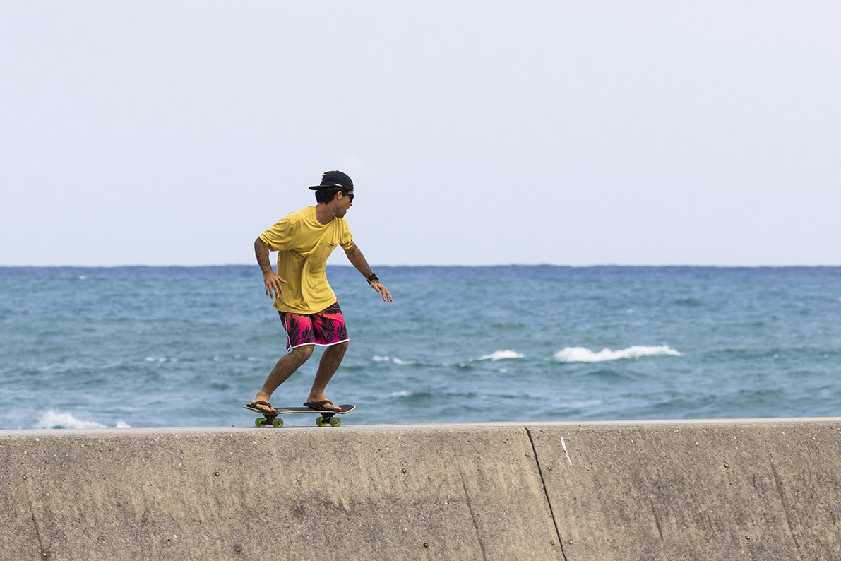 A man riding a skateboard in front of the ocean