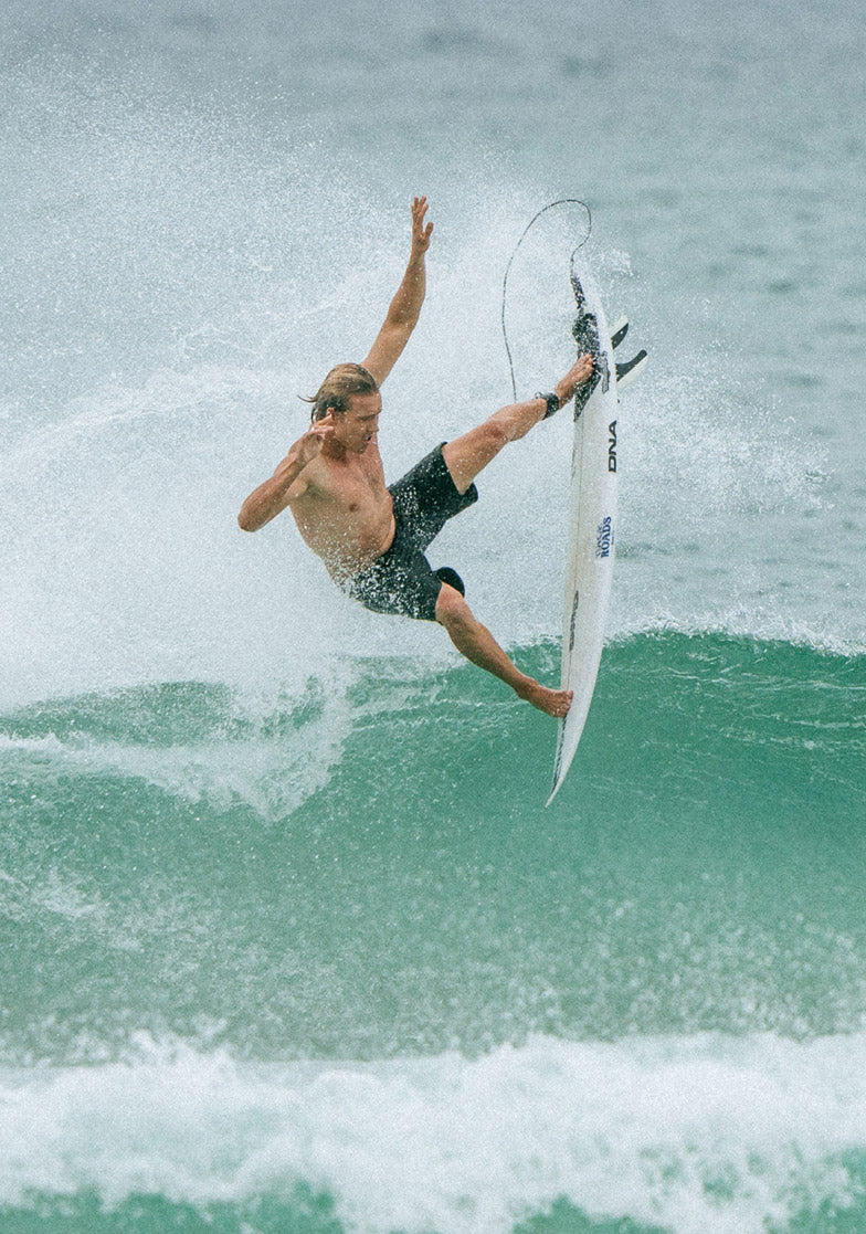 Surfer performing a trick on a wave