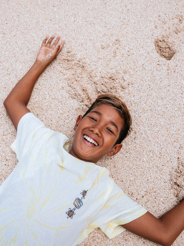 Child lying on a carpet with a smile
