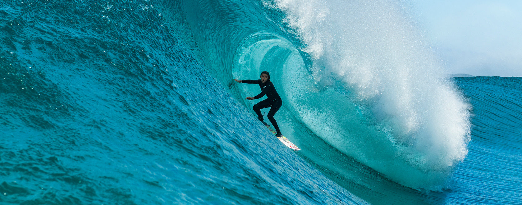 Surfer riding a large wave in the ocean