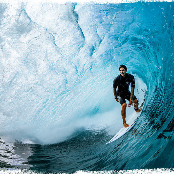 Surfer riding a large blue wave