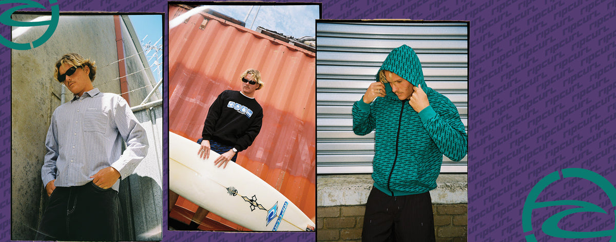 A three-panel collage showing a model wearing different streetwear items: a light blue striped button-down shirt, a black graphic sweatshirt while holding a white surfboard, and a teal textured zip-up hoodie. The panels are set against outdoor backdrops (concrete wall, shipping container, corrugated metal) and framed by a purple graphic border with teal wave-like logos.