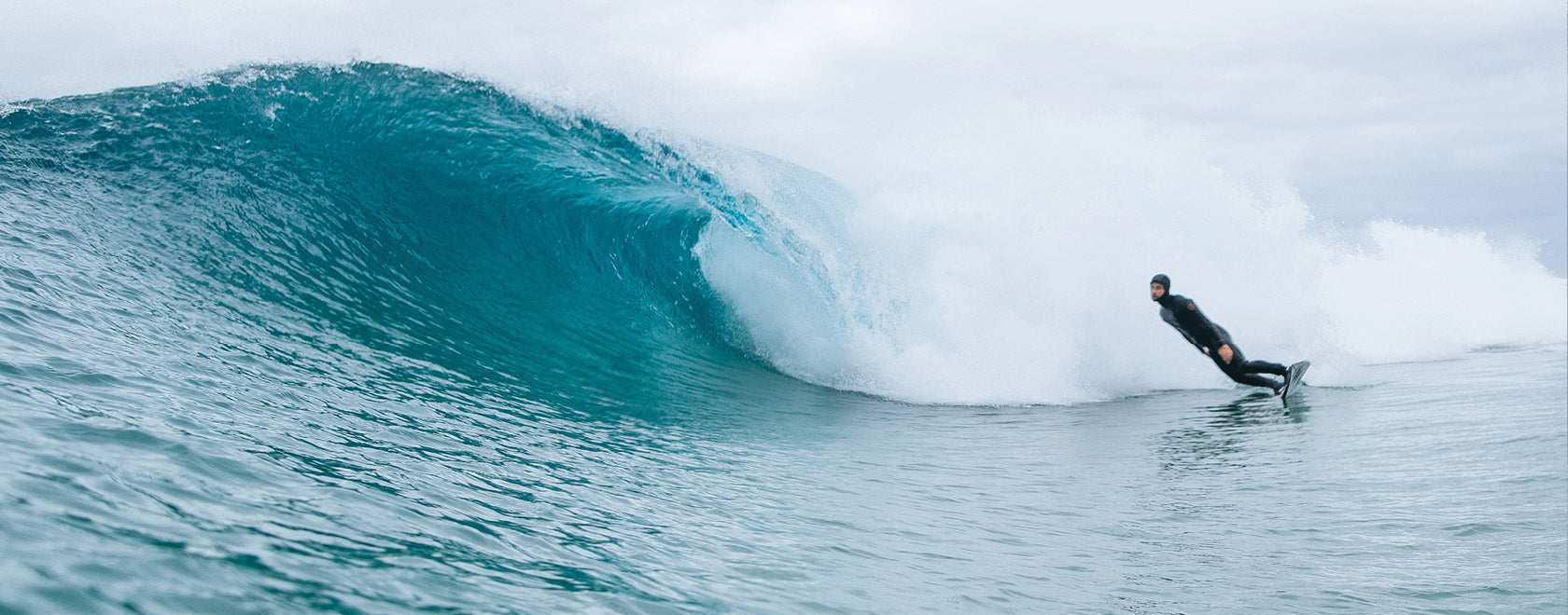 Surfer riding a large wave in the ocean