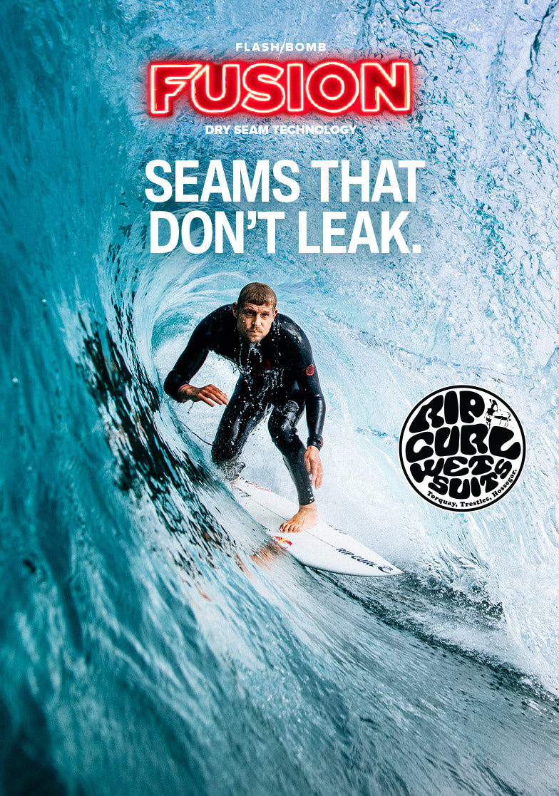 Surfer riding a wave with 'Fusion' advertisement text and logo.