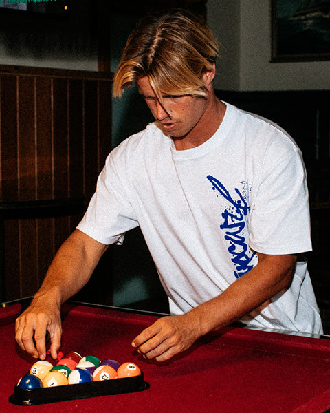 Person arranging pool balls on a pool table