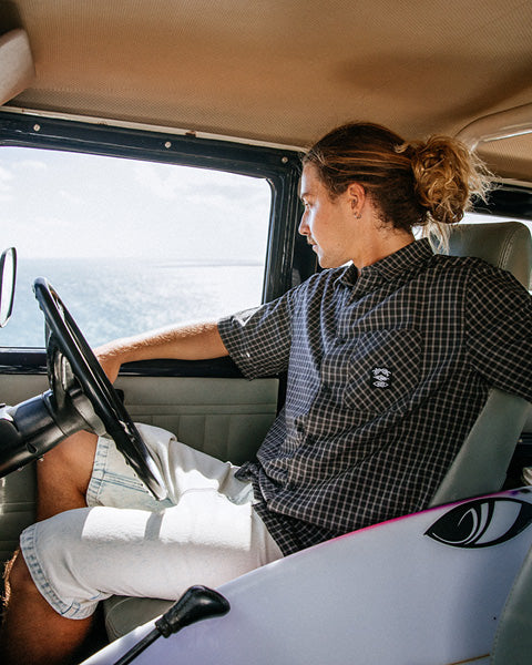 Person sitting inside a vehicle with a scenic view outside