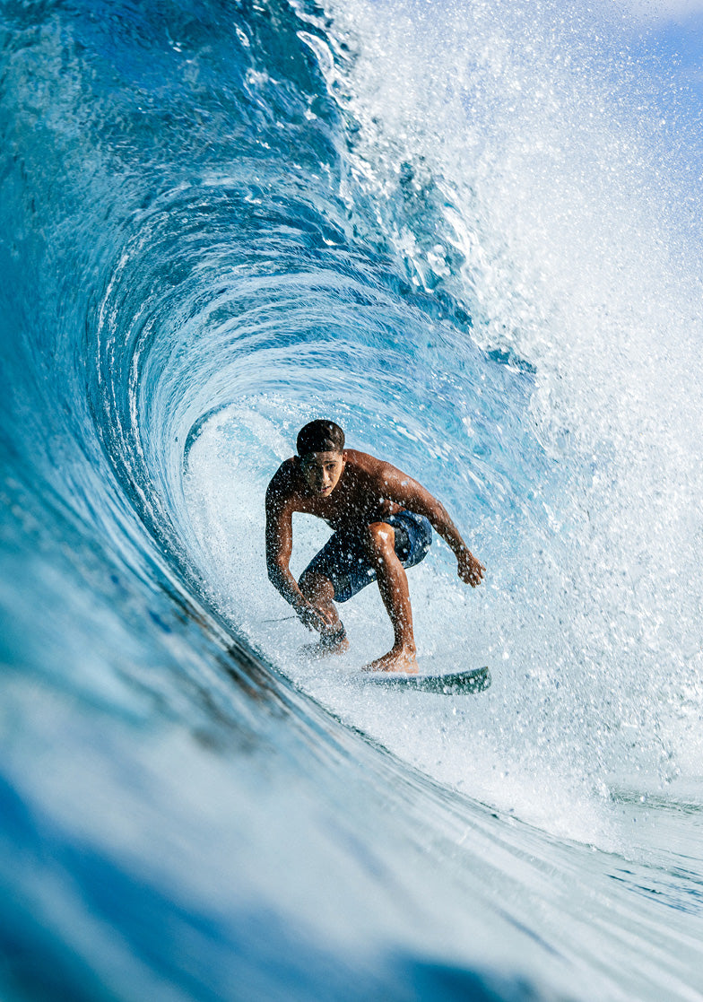 Surfer riding a wave in a tube