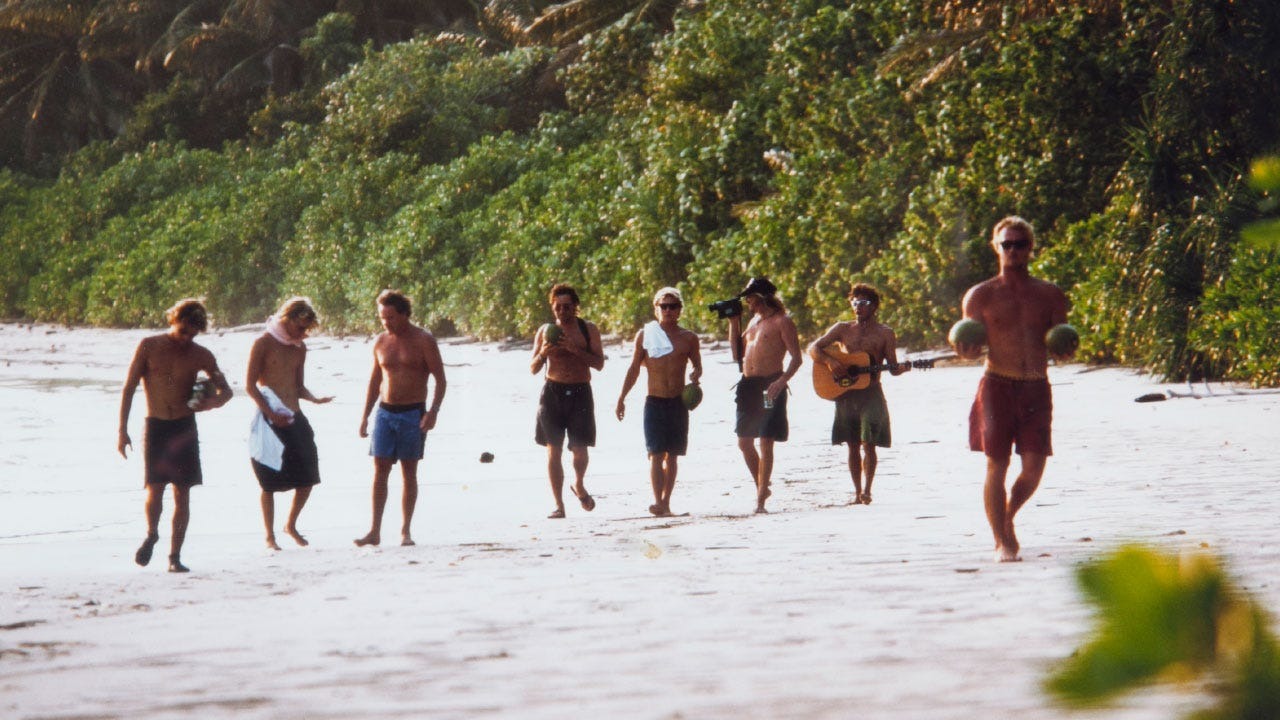 Crew walking along a beach in Indonesia