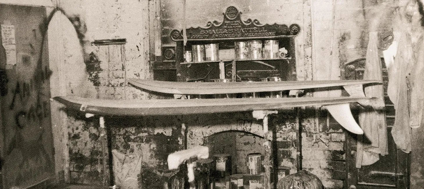 Vintage interior with a longboard on a shelf, surrounded by rustic decor.