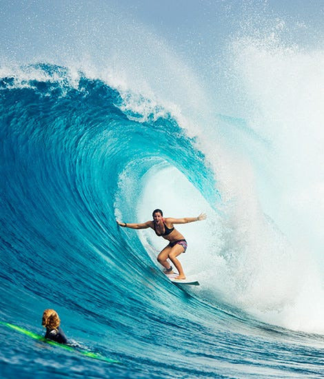 Huge wave with a woman surfing