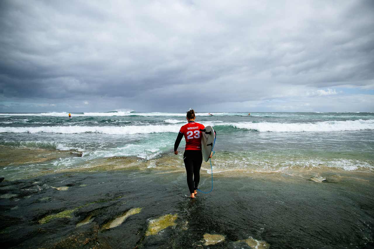 Tyler Wright taking a moment before walking into the water