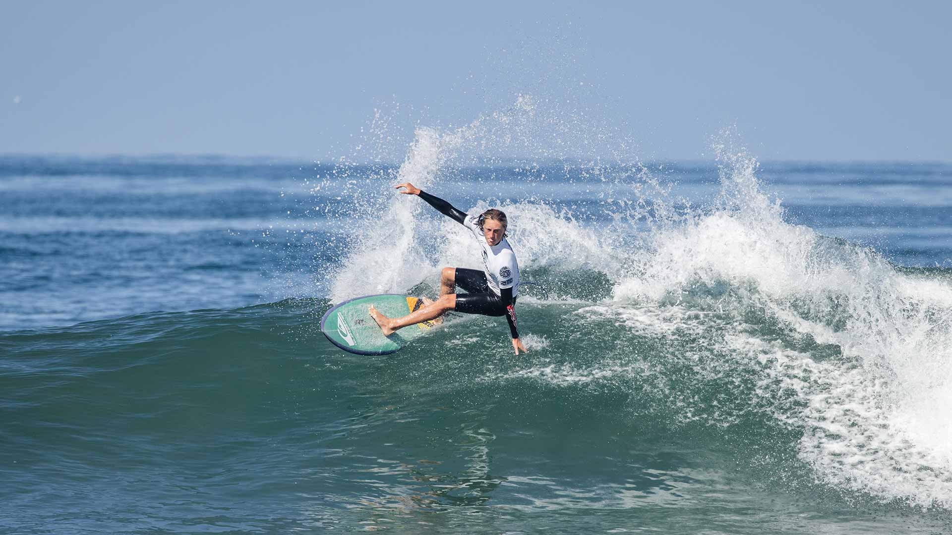 Grom surfing their heat at Huntington Beach