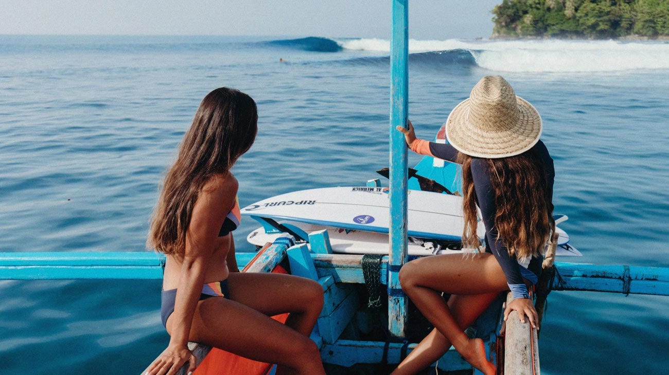 Rip Curl women sitting on a boat in the Mentawais