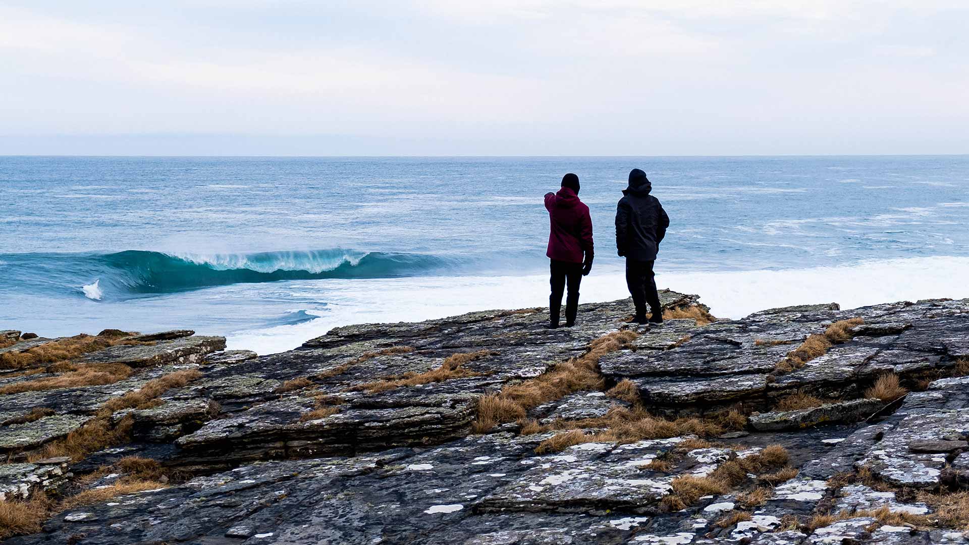 Mason Ho and friend on the windy cliffs of Scotland looking for Waves.