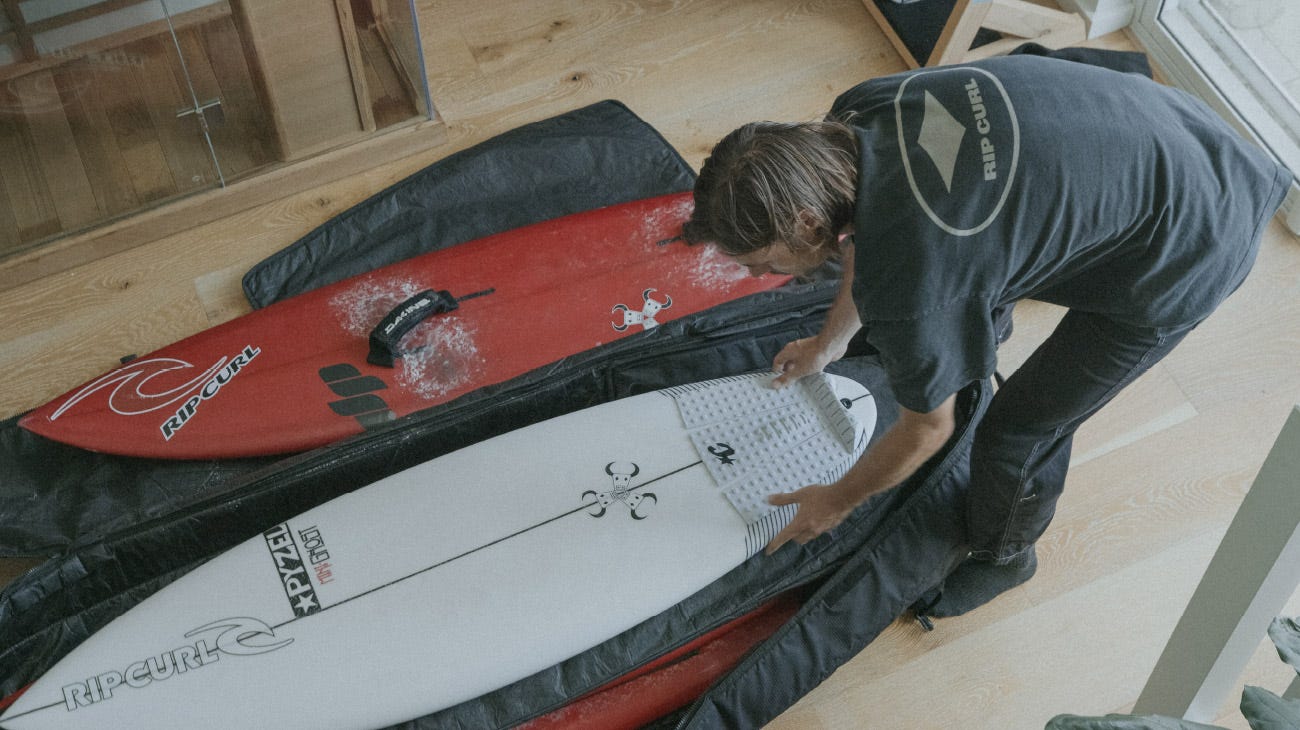 Kipp Caddy packing his surfboard bag
