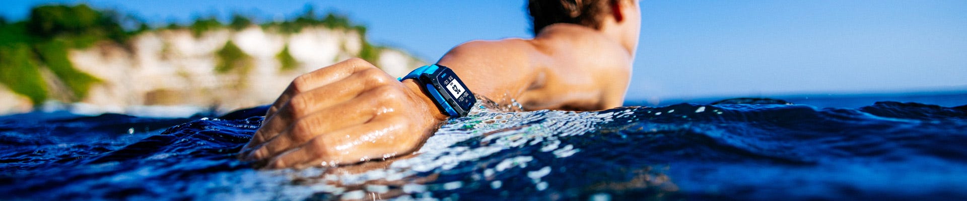 Surfer paddling wearing the blue Search GPS 3 watch