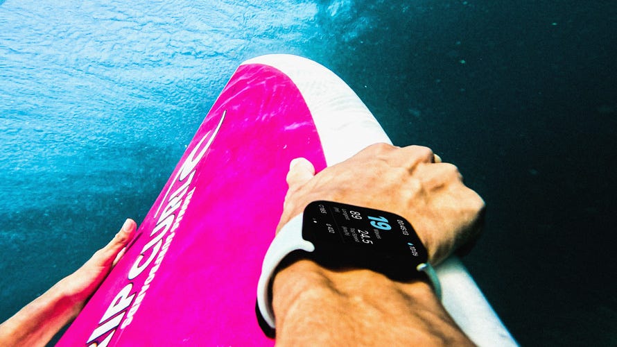 Apple watch watch shot underwater holding a surfboard