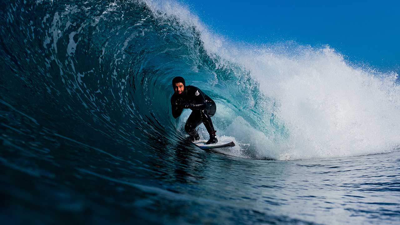 Mason Ho surfing in Scotland in a 4/3 Rip Curl Wetsuit, hood and booties