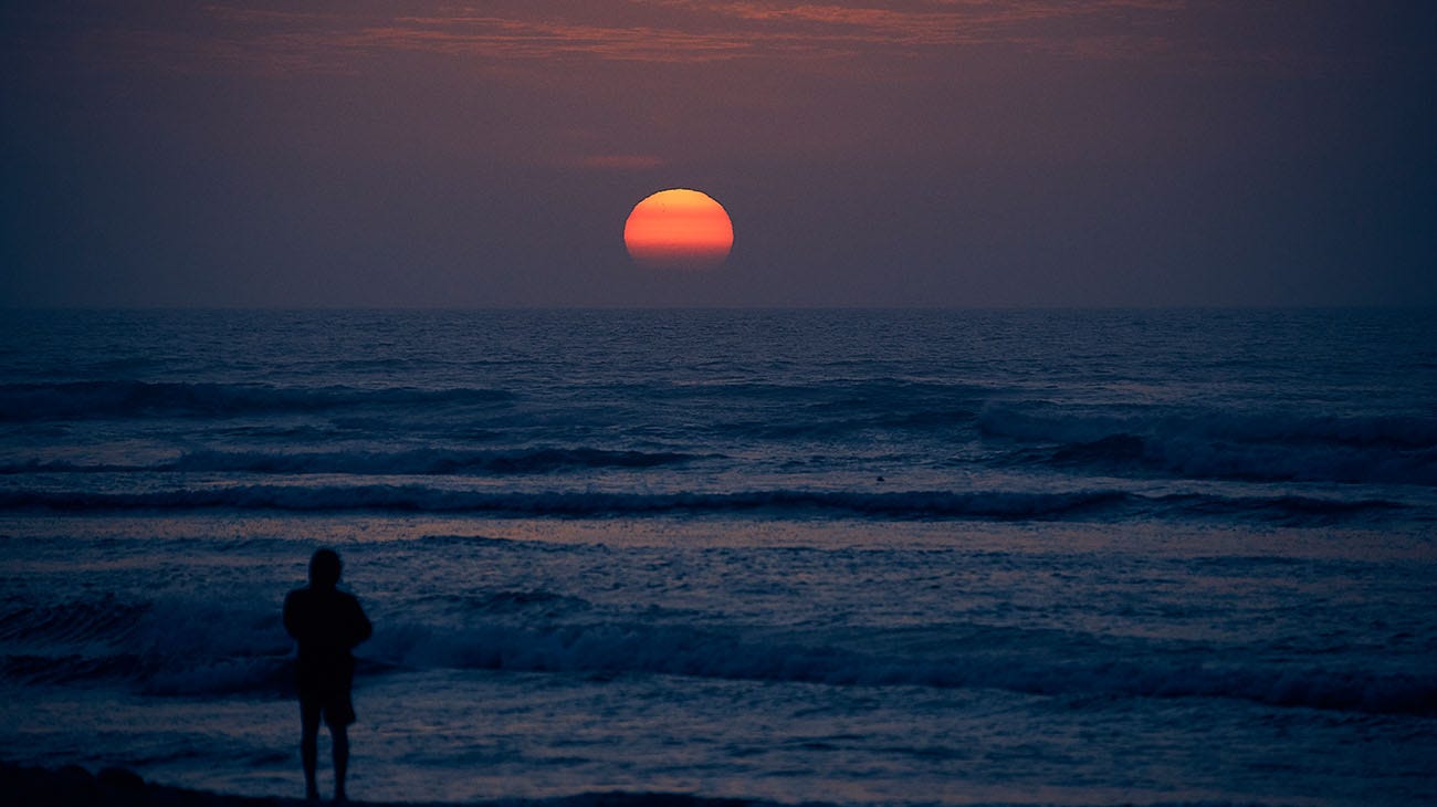 Gabriel Medina on the beach at sunset
