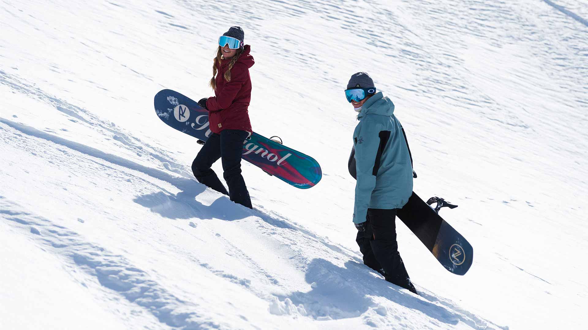 Rip Curl snowboarders treking up a mountain in France