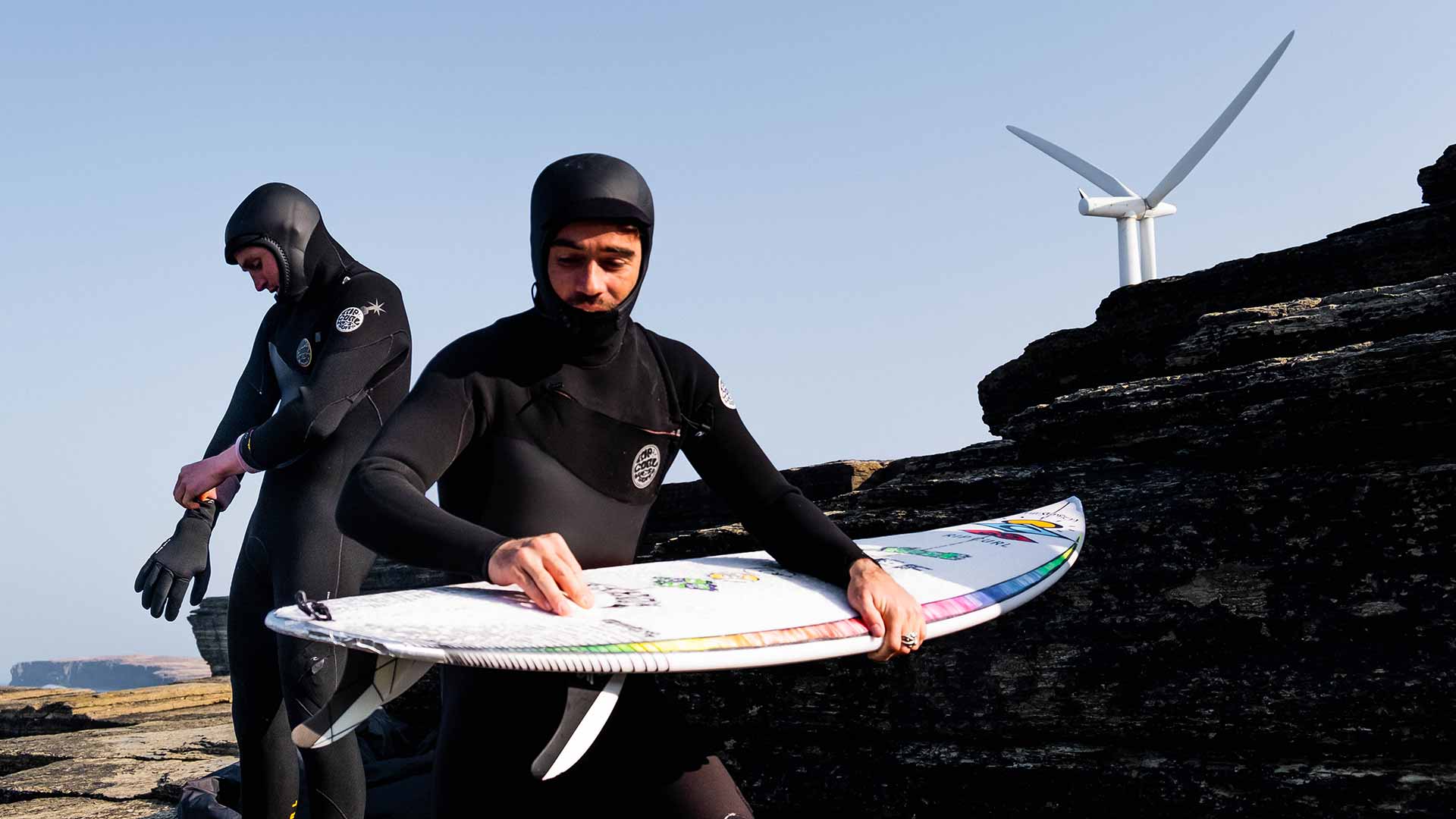 Mason Ho waxing his surfboard in Scotland