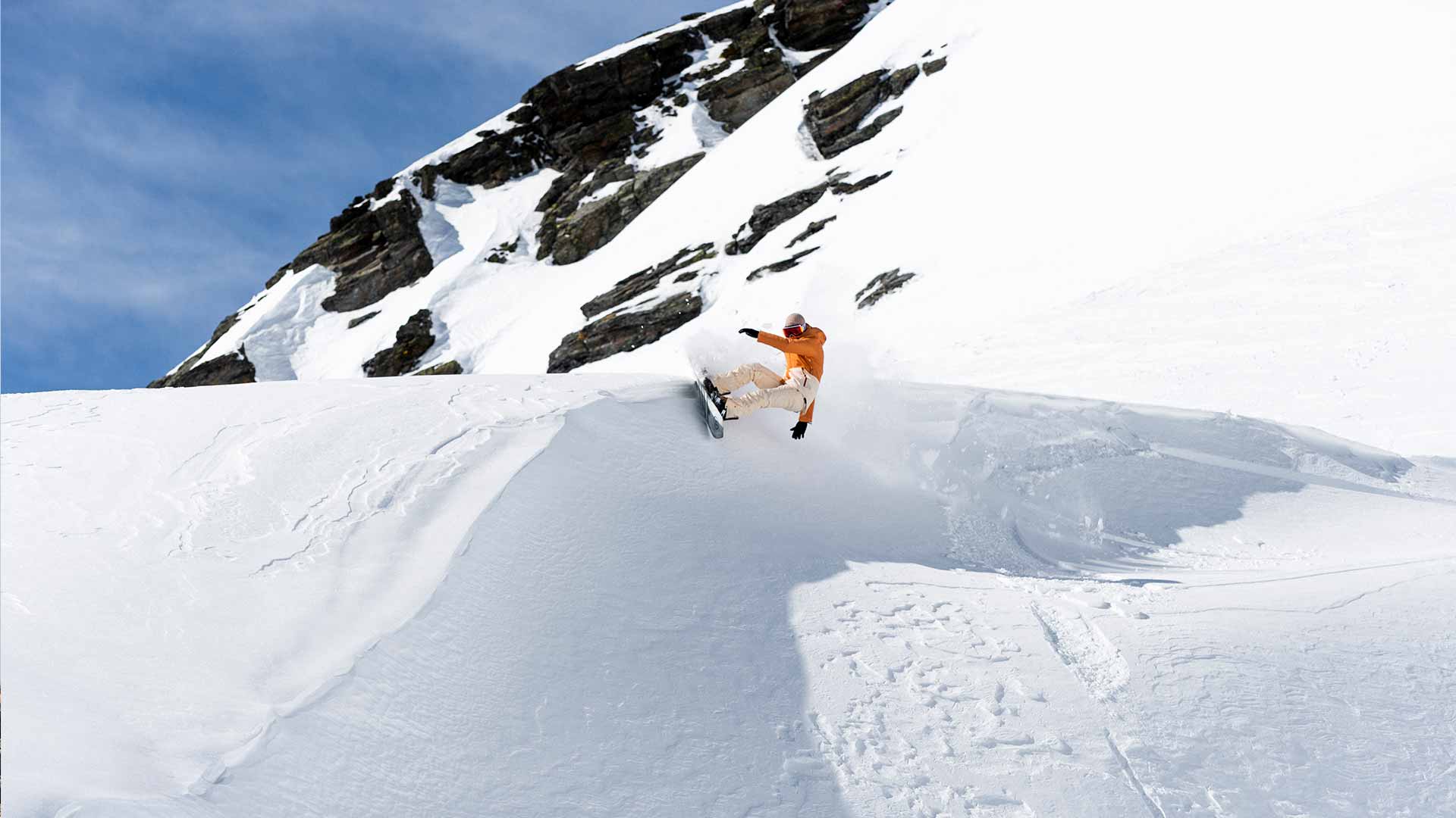 Rip Curl Snowboarder carving up a half pipe in France