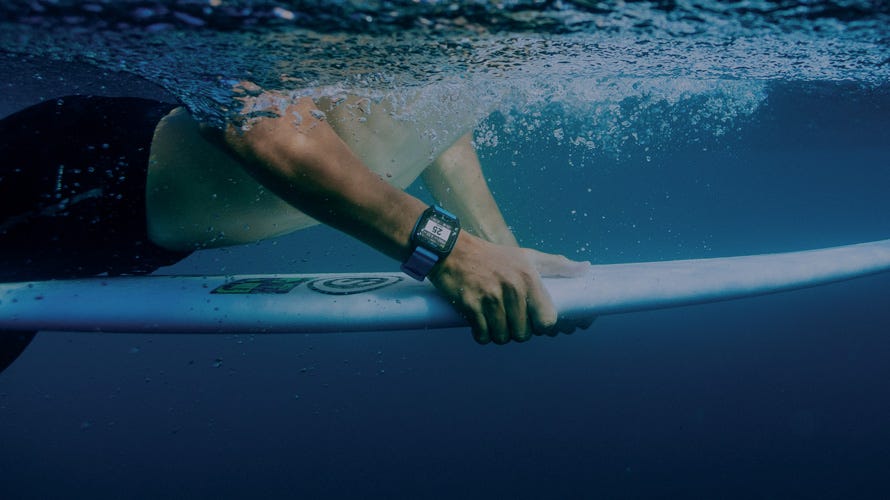 Surfer duck diving under a wave wearing the Search GPS 3 Watch