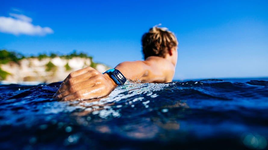 Surfer paddling wearing the blue Search GPS 3 watch
