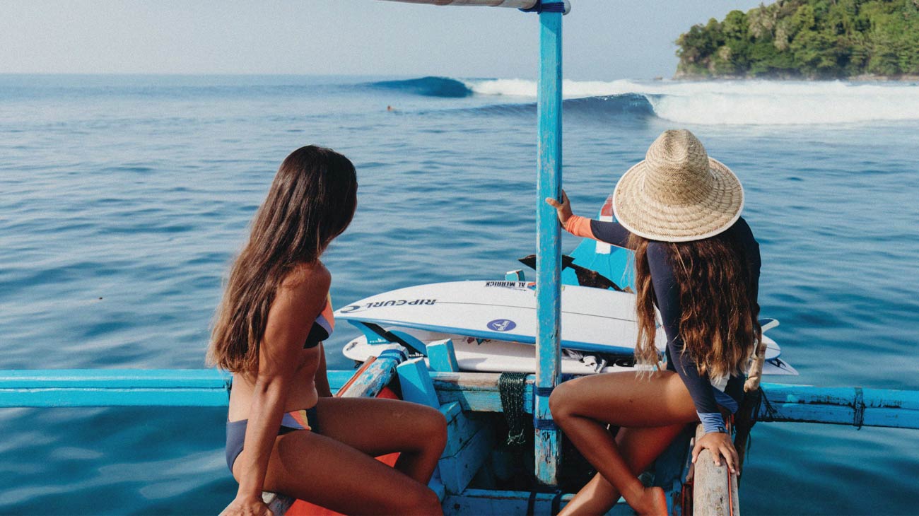 Rip Curl women crew sitting on a boat in Indo watching the waves come in. 