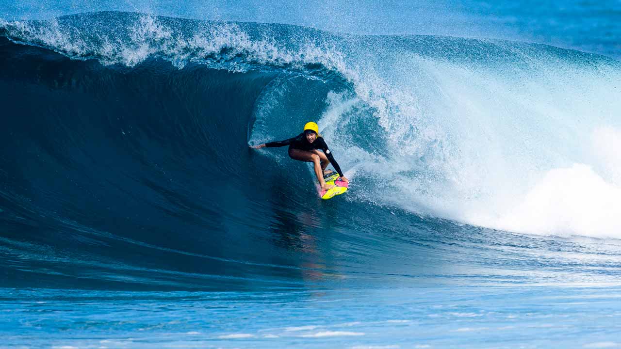 Erin Brooks dropping in on a set at Pipeline, Hawaii