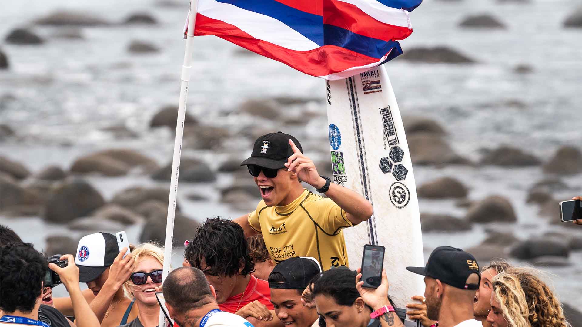 Luke Swanson being chaired across the beach by friends after his win