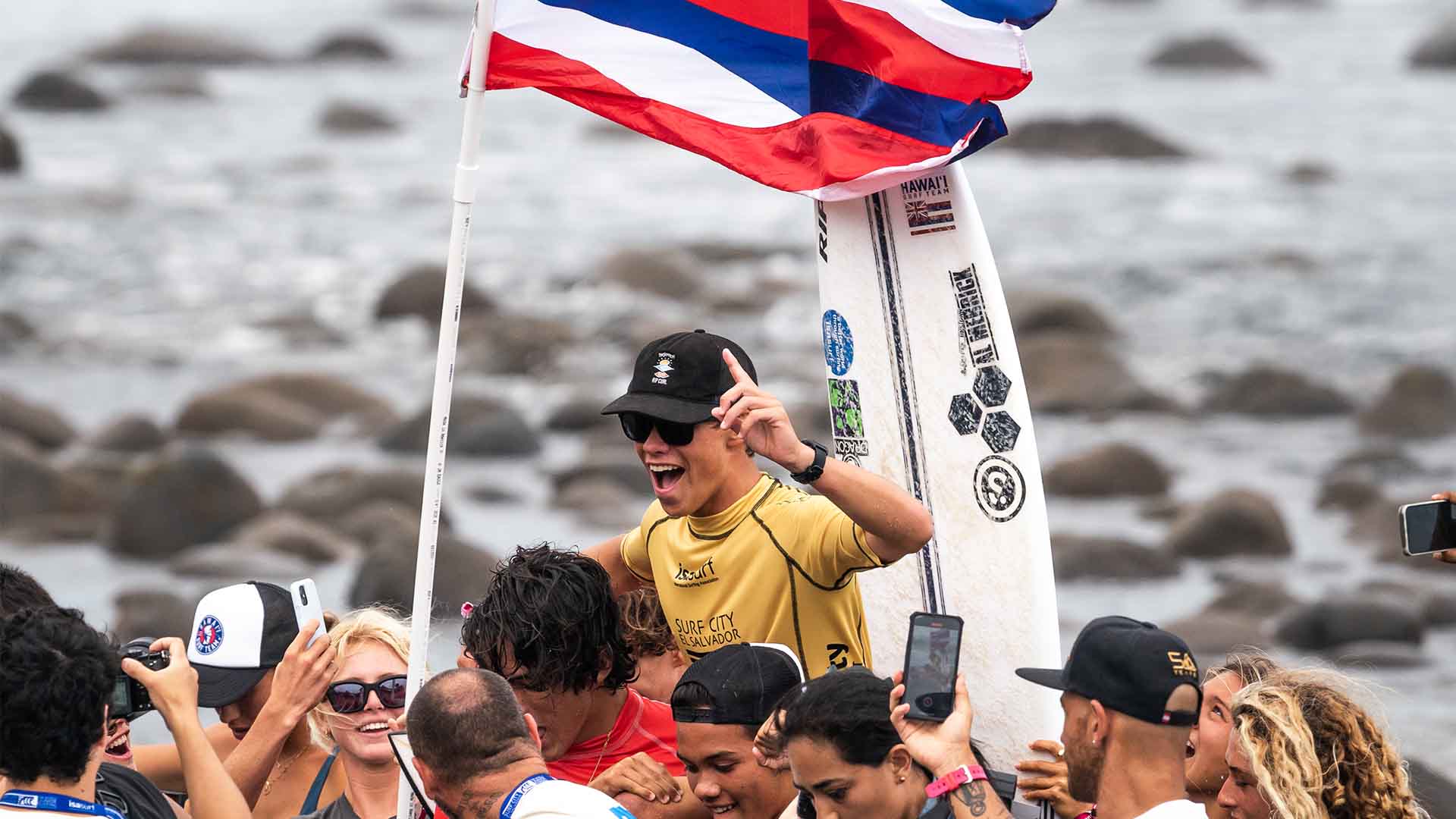 Luke Swanson being chaired across the beach by friends after his win