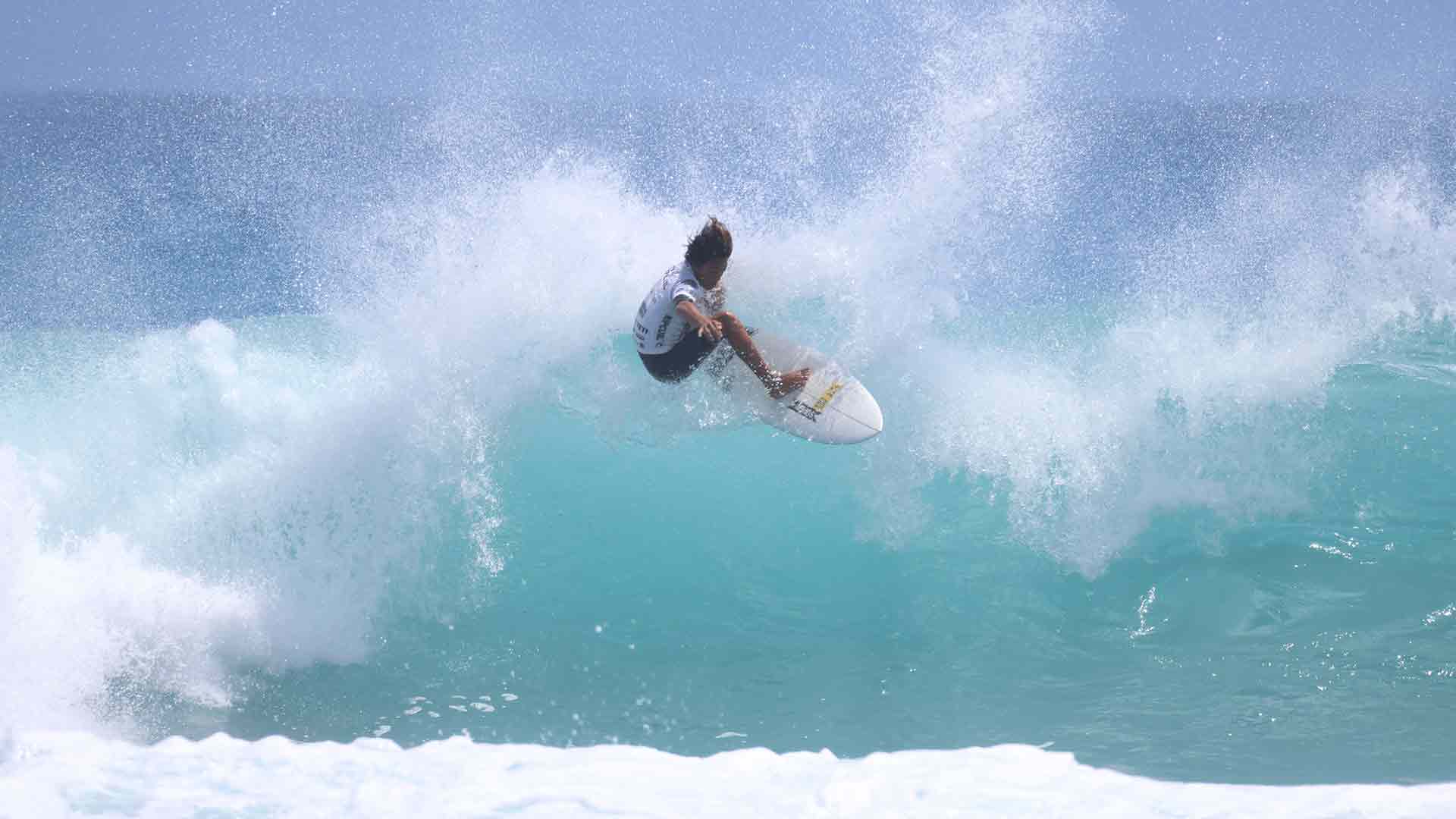 Kenny Nishimoto surfing his heat in Hawaii