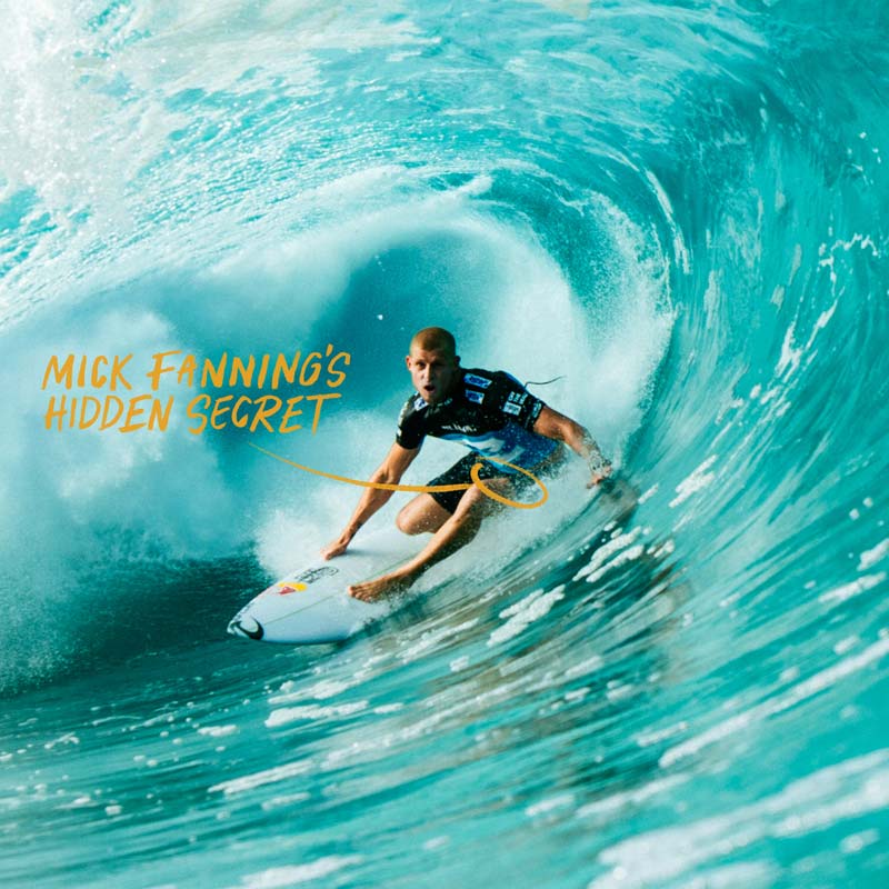 Mick Fanning getting barreled with text overlay; "Mick Fanning's Hidden Secret" and arrow pointing to shorts. 