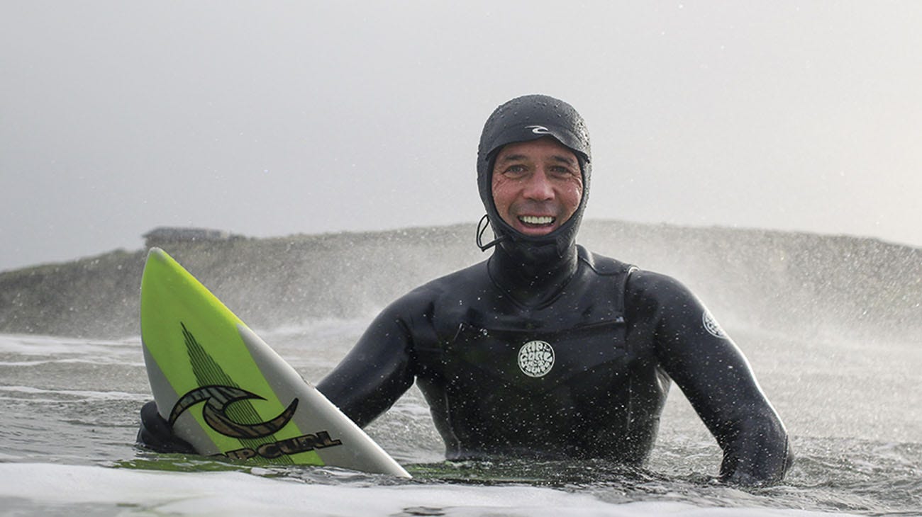 Pablo Gutierrez Surfing In a Hooded Wetsuit