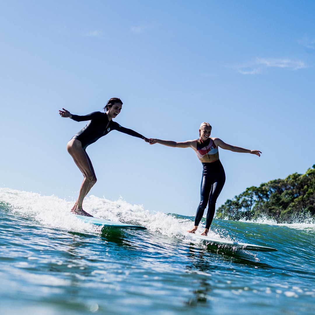 Victoria Vergara and Mason Schremmer longboarding in Noosa