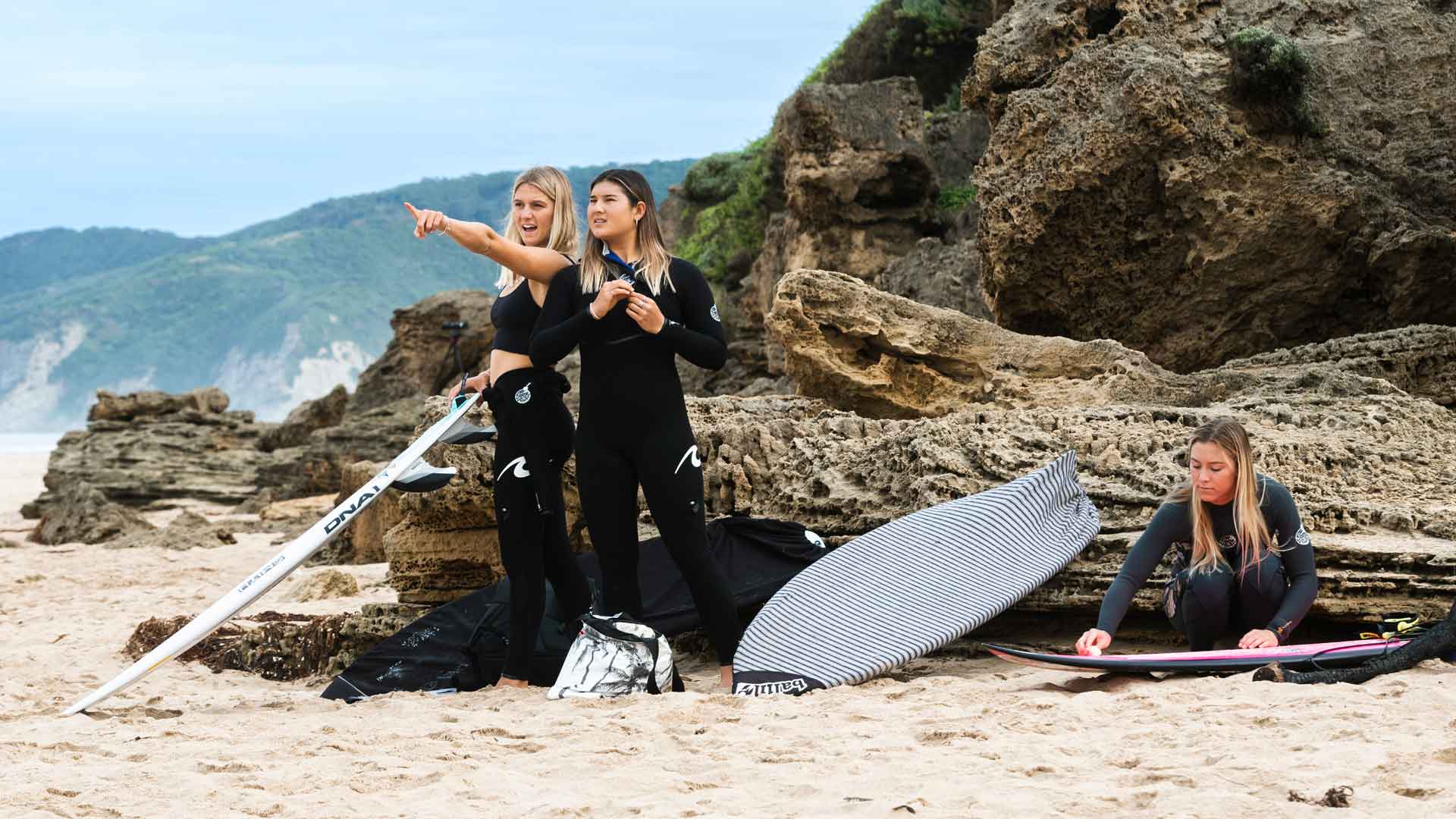 Molly Picklum and Brisa Hennessy doing a surf check in Johanna