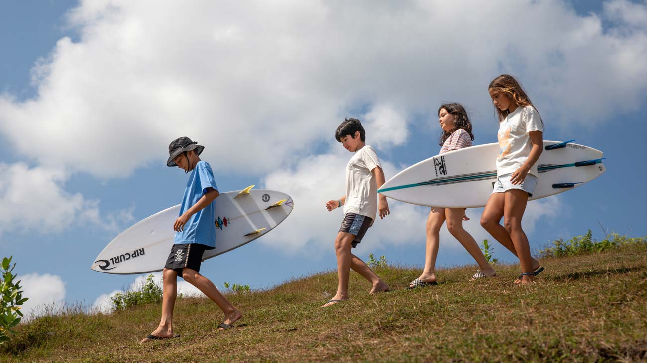 Rip Curl groms standing with their boards in Bali