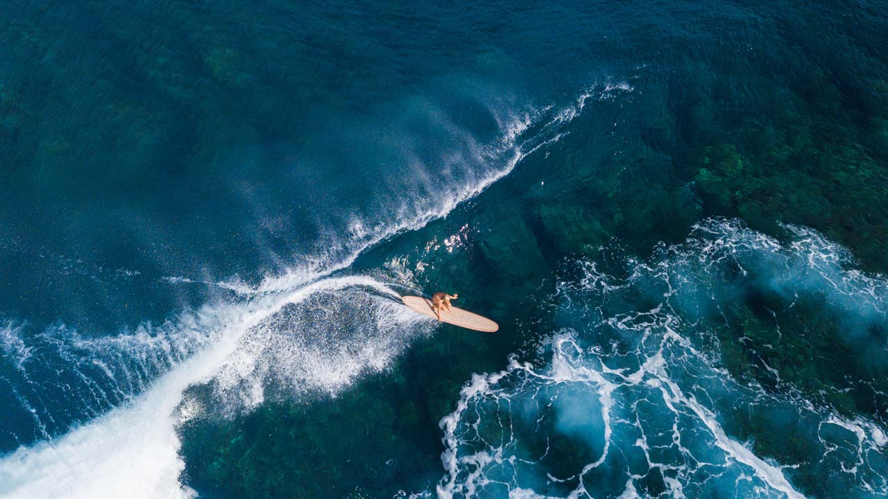 Aerial photo of Mason Schremmer surfing in Fiji