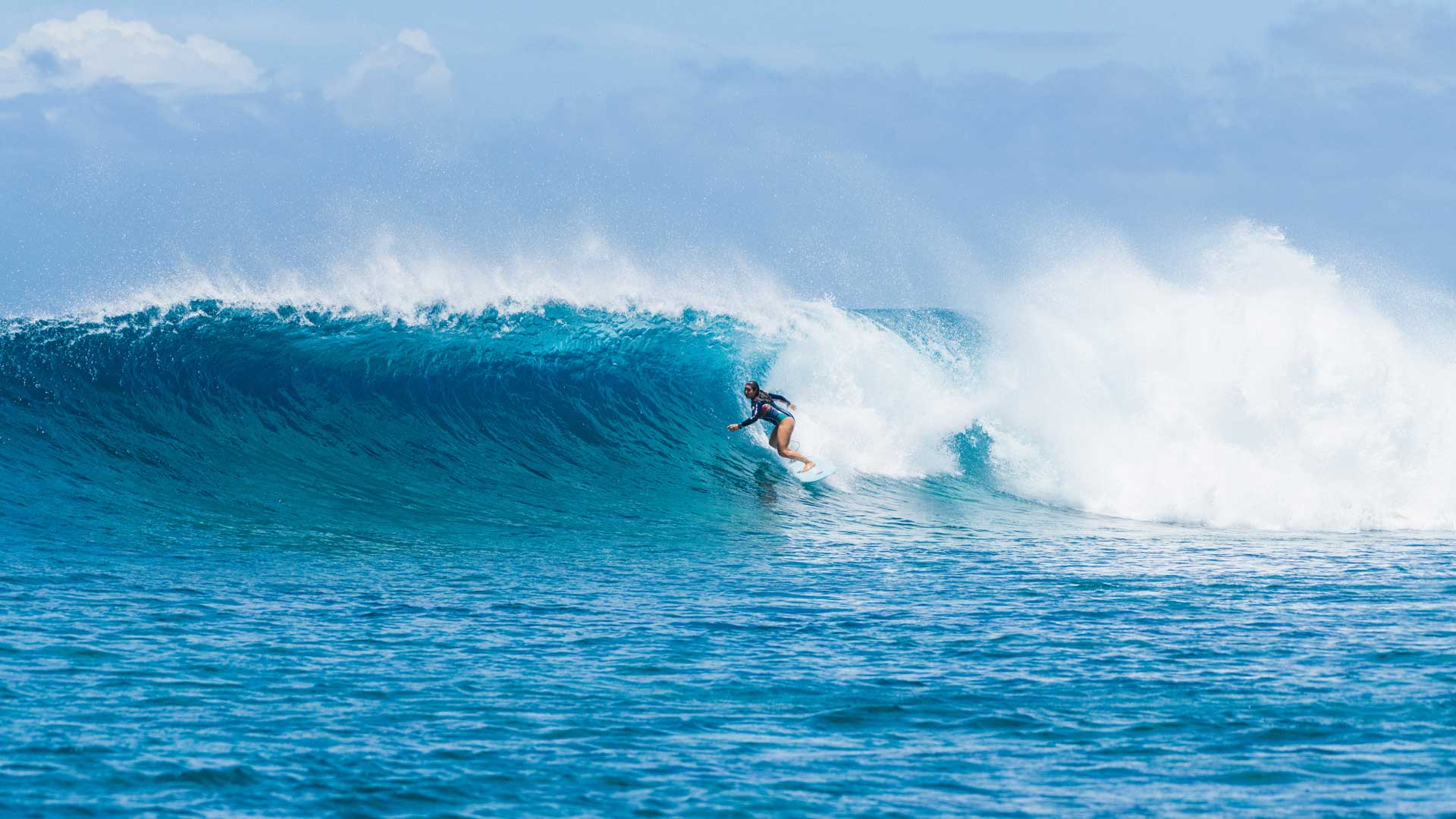 Brisa Hennessy surfing her home break in Fiji