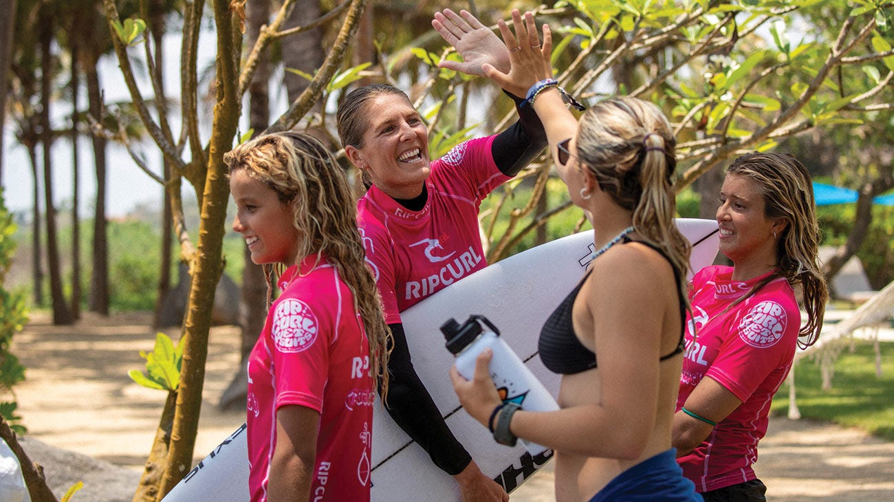 Steph Gilmore hi-fiving groms
